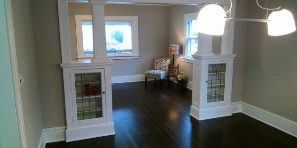 Interior renovation with gray walls, white built ins and trim, and ebony stained hardwood floors