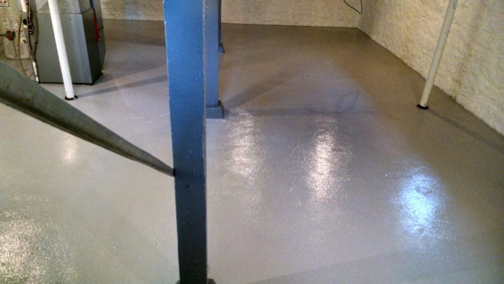 unfinished basement painted gray floor and waterproofed walls clean