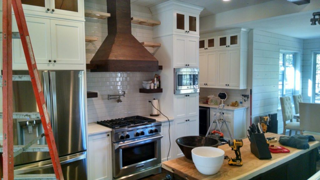 Rustic modern kitchen renovation, white cabinets under construction